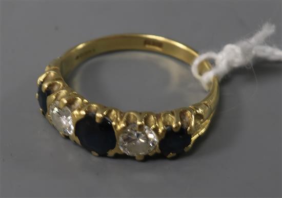 An 18ct gold, sapphire and diamond five stone half hoop ring, size Q.